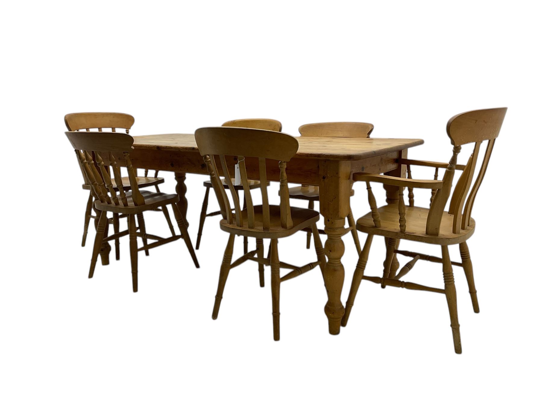 Pine farmhouse dining table, rectangular top with rounded corners, raised on turned supports; together with a set of six (4+2) spindle-back dining chairs