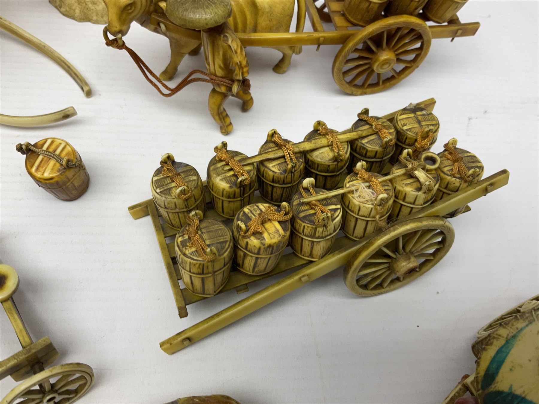 Collection of Japanese celluloid figures, including Rickshaw groups, fishing scene, oxen etc 