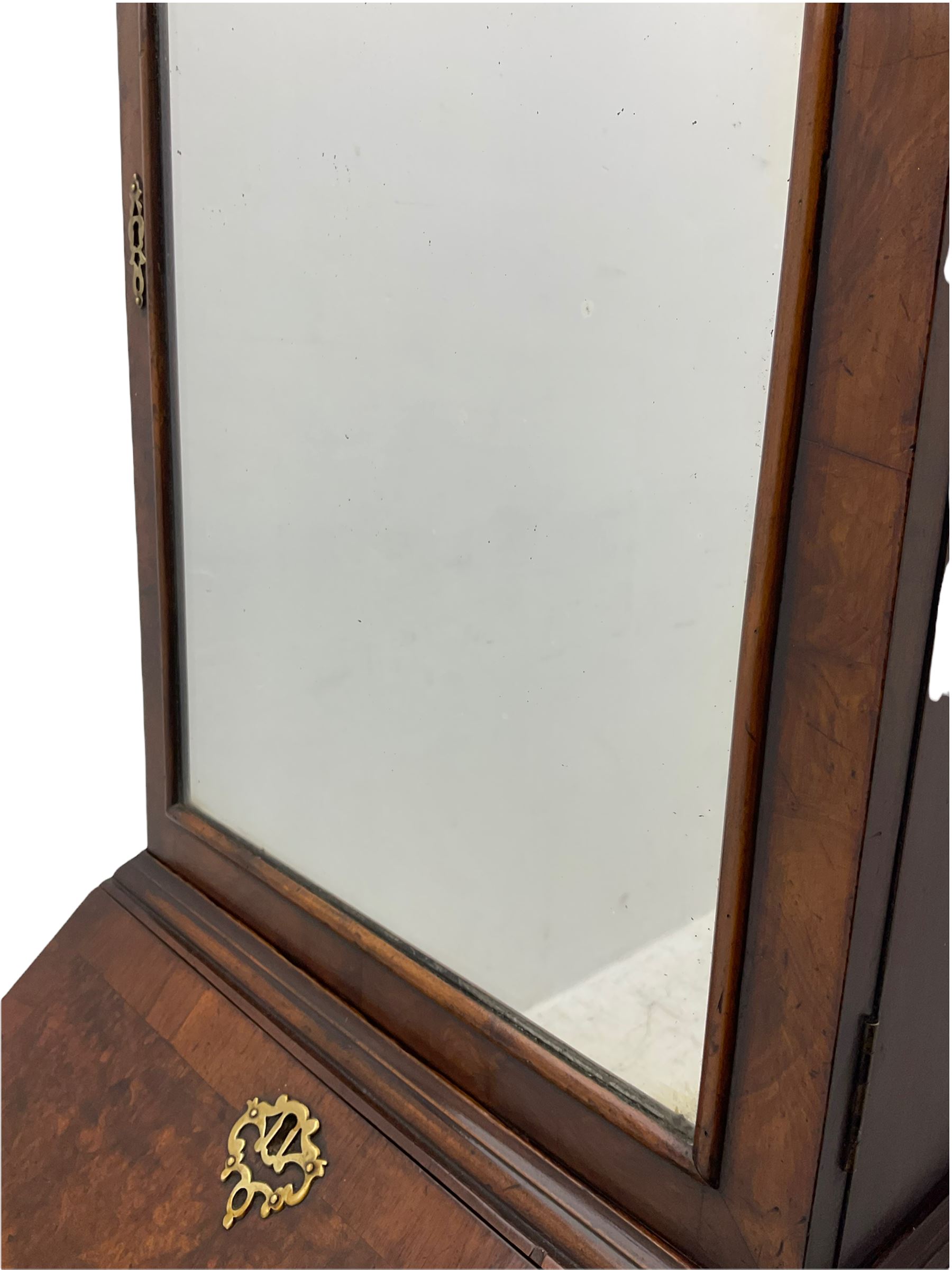 Small early 20th century Queen Anne style bookcase on bureau secretaire, the moulded arched pediment over mirrored door in shaped frame, the bureau fitted with fall front enclosing curved fitted interior, cushion moulded drawer over single drawer, on scroll and shell carved cabriole supports