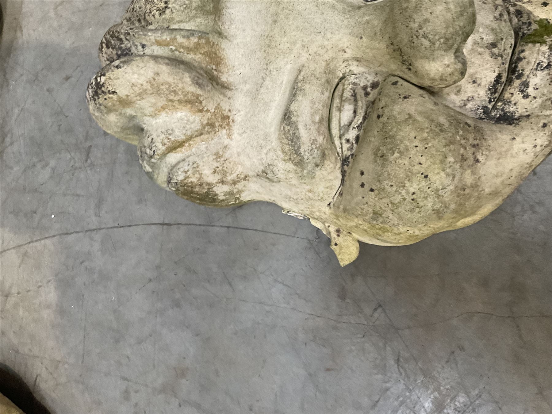 Four grotesque garden wall masks