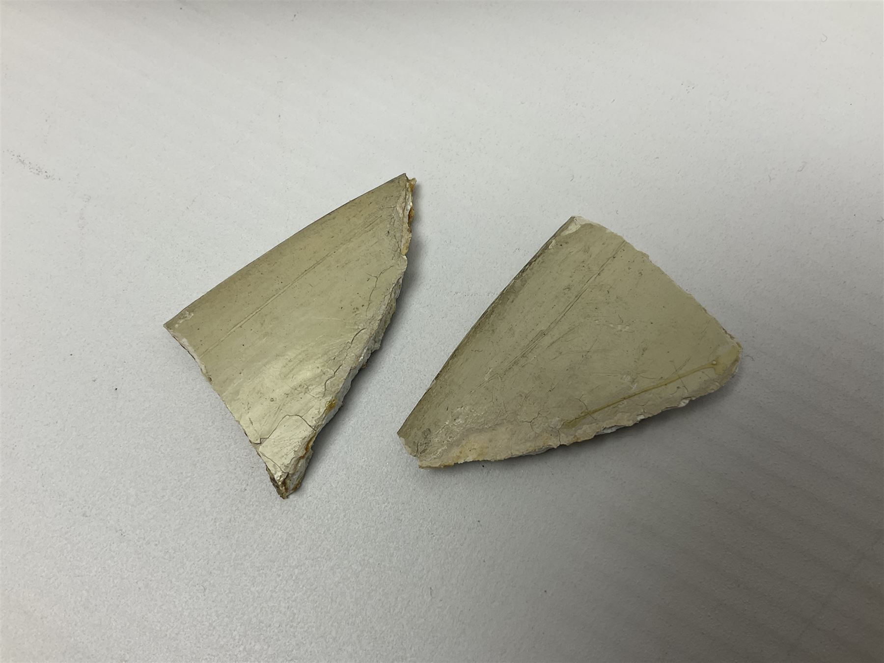 Early 18th century Delft marriage plate, of circular form with dished centre, the centre inscribed and dated 'Thomas and Elizabeth Kockerill Bridlington Key 1715' within a crowned C scroll cartouche, flanked by demi-griffins, above a putto head and tassels, within a wide foliate border, D34cm
