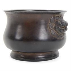 Chinese bronze censer, of circular bellied form with temple lion mask handles, upon a circular foot, with apocryphal six character Xuande mark within a border of two dragons chasing a pearl, H7.5cm D10/5cm
