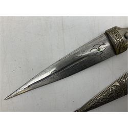 Caucasian qama or kindjal dagger, the 15cm pointed double edged blade with centre fuller and two-piece horn grip;  in nickel plated scabbard with panels of figures and script L28.5cm overall; and eastern knife with 20.5cm curving blade and decorative horn grip; in leather covered scabbard (2)