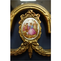  Wall mirror in gilt scroll work frame with oval Serves style porcelain inset, 59cm x 97cm   
