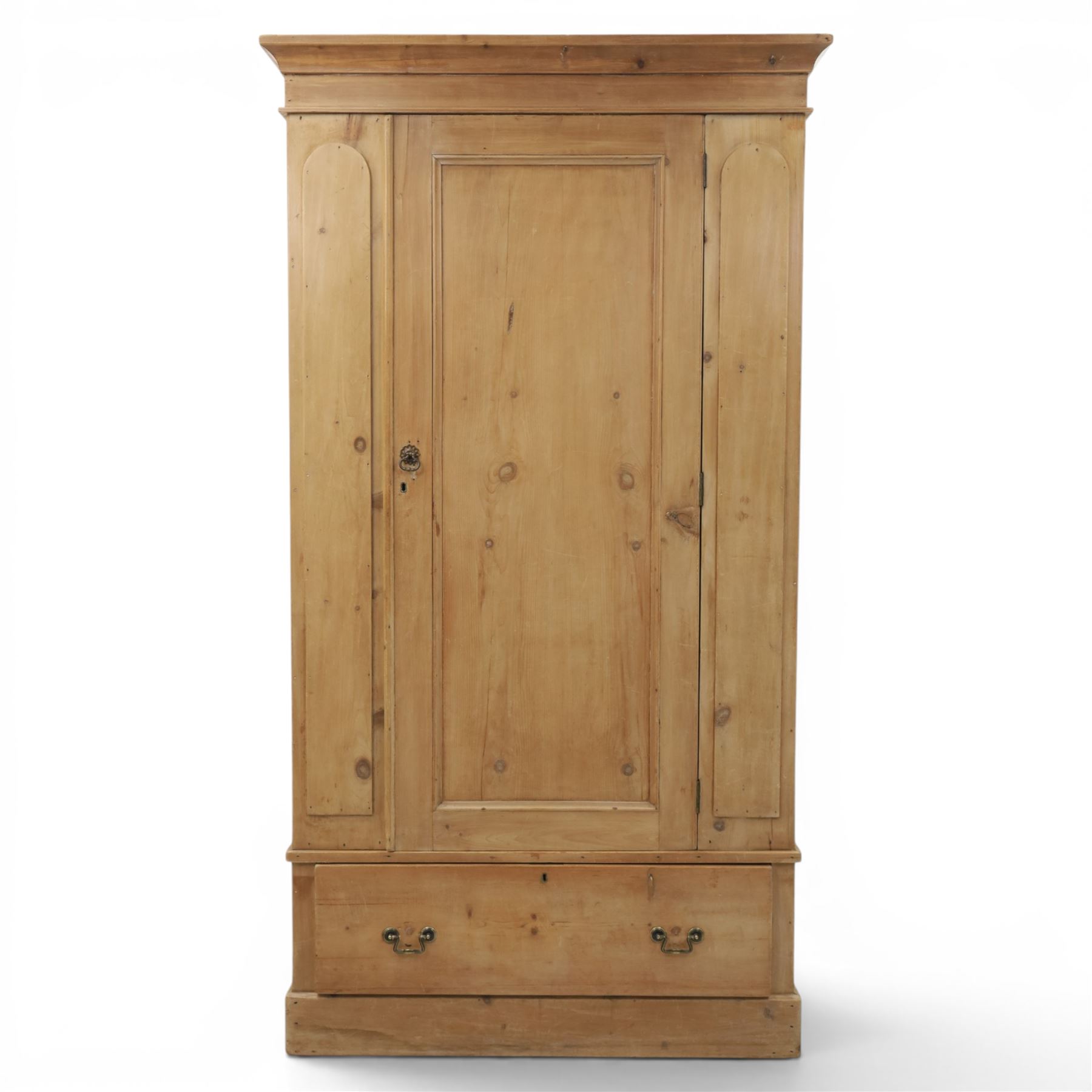 Traditional waxed pine single wardrobe, featuring single panelled door above base drawer, loop handles