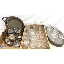 A quantity of assorted silver plate, to include a pair of oval trays with engraved foliate detail to the centre and pierced gallery, a circular twin handled tray, a waiter with pie crust rim, a faceted teapot with matching milk jug and twin handled sucrier, another tea pot with matching twin handled sucrier, three bud vases, together with a group of glassware, to include a set of six champagne saucers with air twist stems, six cut claret glasses, six port glasses, three decanters, vases, etc.   