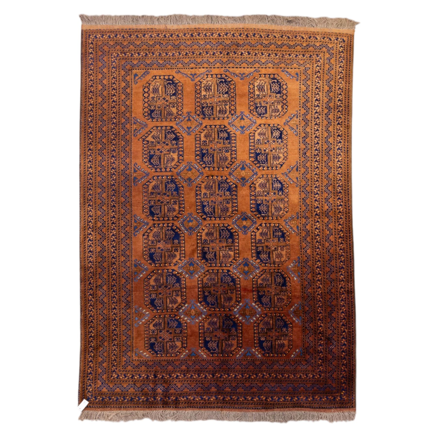 Pakistani Bokhara hand-knotted carpet, camel field decorated with rows of large tekke style octagonal guls enclosing stylized geometric motifs, interspersed with small stepped diamond devices within multiple geometric borders, with fringe ends 