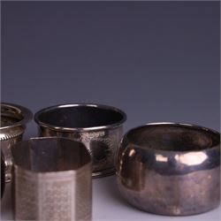 Seven silver napkin rings, of varying design and each with engraved initials, all hallmarked