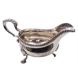 Set of three George III silver sauce boats, each of typical form with gadrooned rim, and acanthus capped scroll handle, upon three shell mounted shell pad feet, one example with engraved crest to body, hallmarked George Methuen, London 1760 including handle H13cm, approximate total weight 44.73 ozt (1391.5 grams)