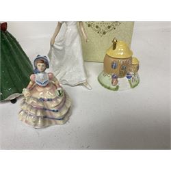 Two Coalport cottages, comprising Teapot cottage and Easter Cottage, together with four Royal Doulton figures, including Holly and Friendship 