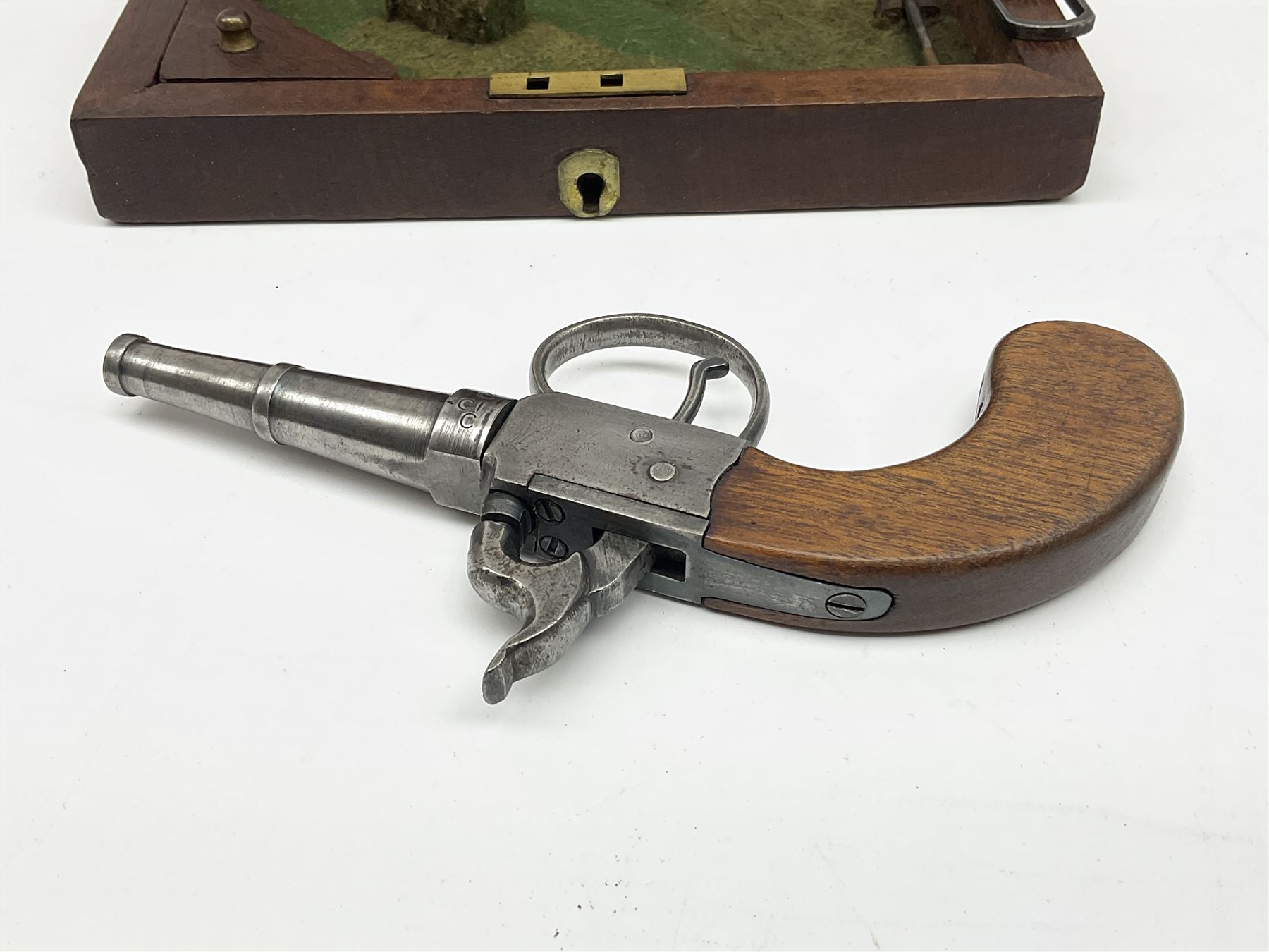 Scratch-built copy of a 19th century percussion cap pistol with 7cm tapering cannon style turn-off barrel, lock-plate inscribed 'F. Fox' and mahogany bag stock L17.5cm overall, in fitted mahogany box with inlaid crest chased mother-of-pearl cartouche and double-ended spanner