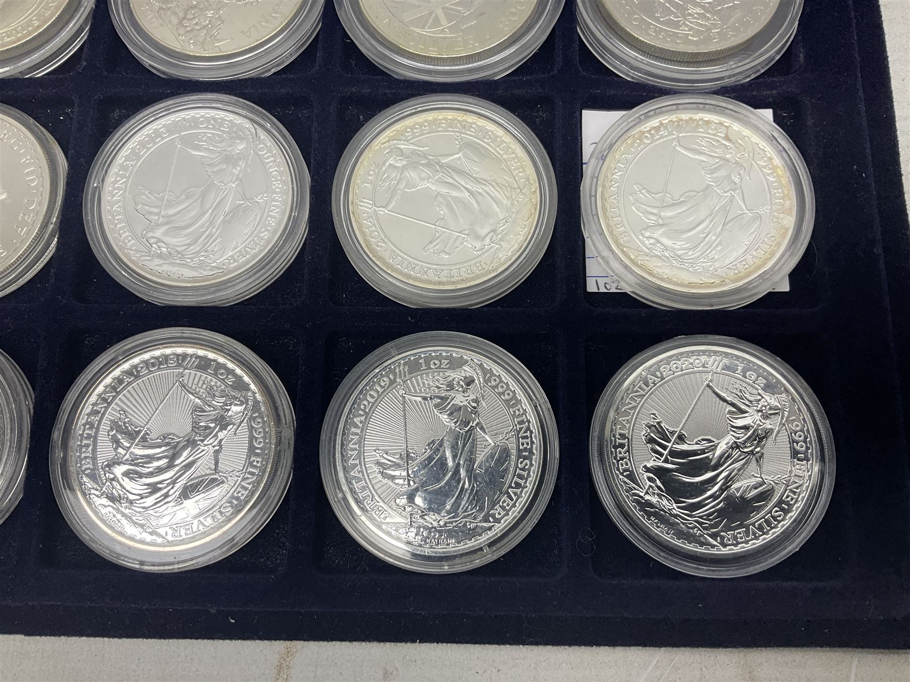 Twenty-four Queen Elizabeth II Britannia one ounce fine silver two pound coins, dated 1998, 1999, 2000, 2001, 2002, 2003, 2004, 2005, 2006, 2007, 2008, 2009, 2010, 2011, 2012, 2013, two 2014, 2015, 2016, 2017, 2018, 2019 and 2020 (24), housed on a coin tray