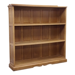  Bob 'Wrenman' Hunter oak bookcase, adzed top with raised back carved with signature Wren, two shelves with panelled back and sides on a stepped skirted base, W125cm, D30cm, H128cm  