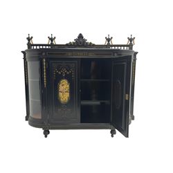 Victorian ebonised credenza side cabinet, raised balustrade back with urn finials and a central carved cartouche, carved and gilded with floral garland decoration, central doors with gilt panels painted with figures sitting over a lake enclosing two shelves, flanked by applied bellflower detail and glazed bow-front side doors, raised on ring turned feet with castors