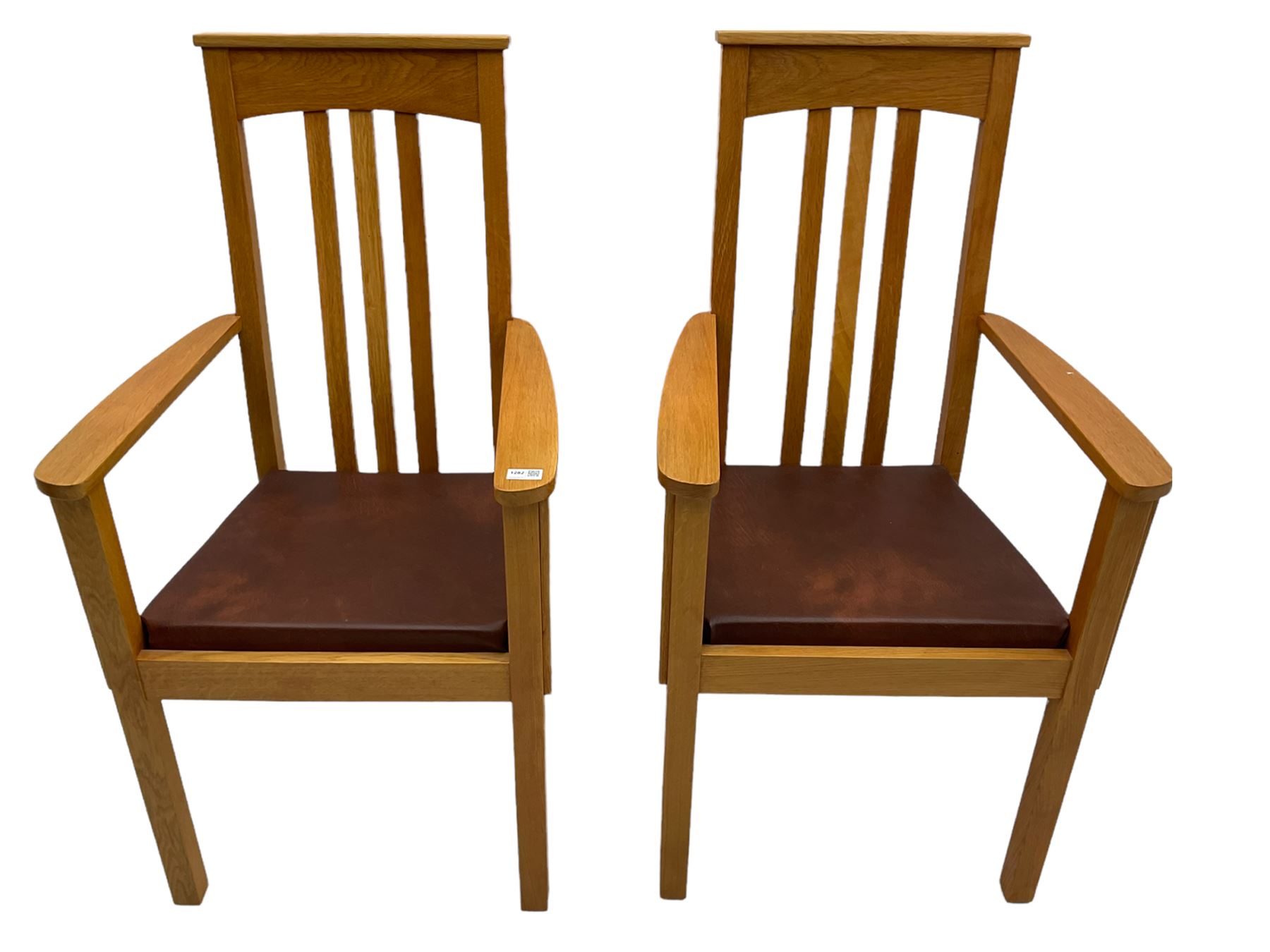 Pair of solid oak Arts and Crafts style carver chairs, inlay to top rail, drop in seat