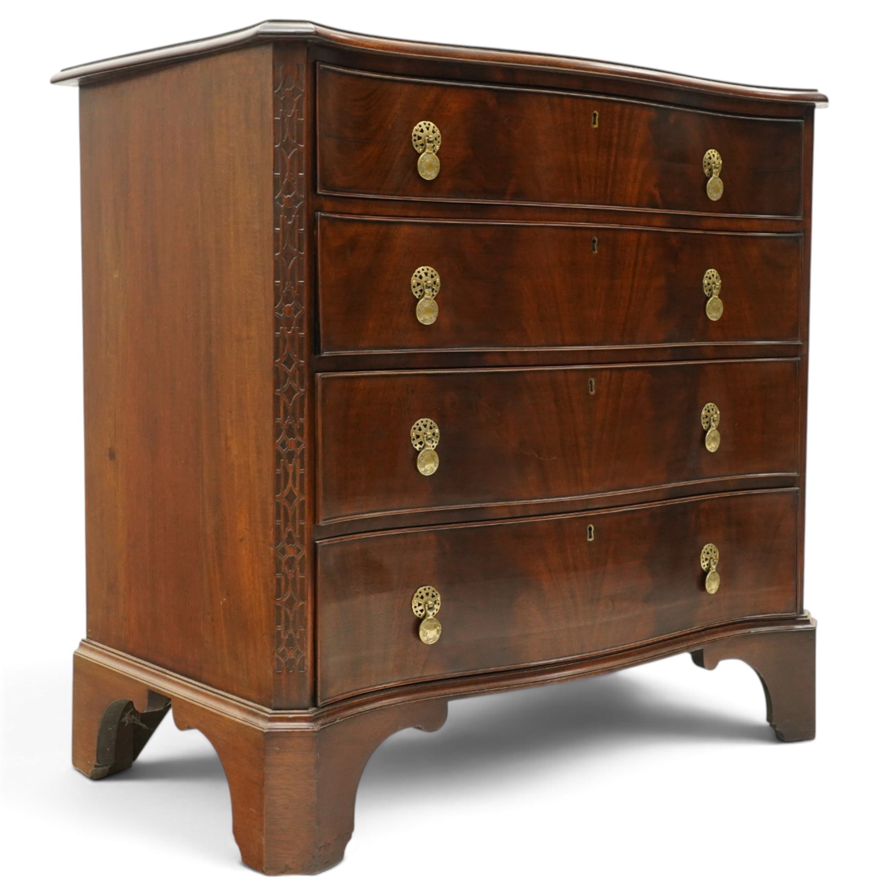 Quality Georgian design mahogany serpentine secretaire chest, the shaped top with moulded edge, fitted with cock-beaded secretaire drawer with button-release fall-front enclosing fitted interior, over three graduating drawers with brass drop handles on pierced circular plates, the canted uprights carved with blind-fret strapwork, lower moulded edge on shaped bracket feet