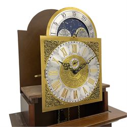 A  20th century longcase clock made to celebrate the millennium in the year 2000, this clock being No 2 of only 200 manufactured by  Richard Broad in Bodmin Cornwall, with a mahogany effect case and traditional swans neck pediment with three brass finials, break arch hood door on a trunk with recessed columns and full length glazed door, on a square plinth with inlay and a shaped base, brass dial with brass spandrels, silvered chapter ring, seconds dial and working moon phase to the arch, weight driven three train movement striking the quarters and hours on 12 gong rods, with a choice of St Michael, Westminster and Wittington chimes, with chime selector and chime/silent facility. With three brass cased weights and gridiron pendulum.





