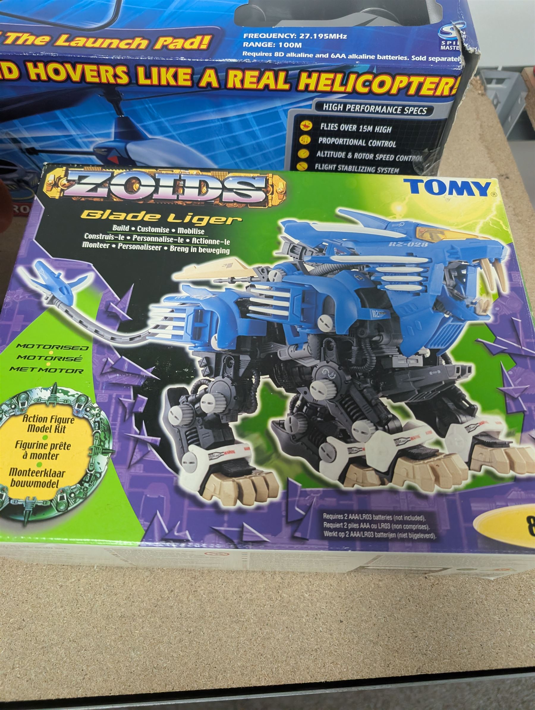 Collection of toys, including Matchbox Old Mother Hubbard's shoe, Tomy Zoids Blade Liger, Air Hogs radio controlled helicopter, diecast tanks etc, 