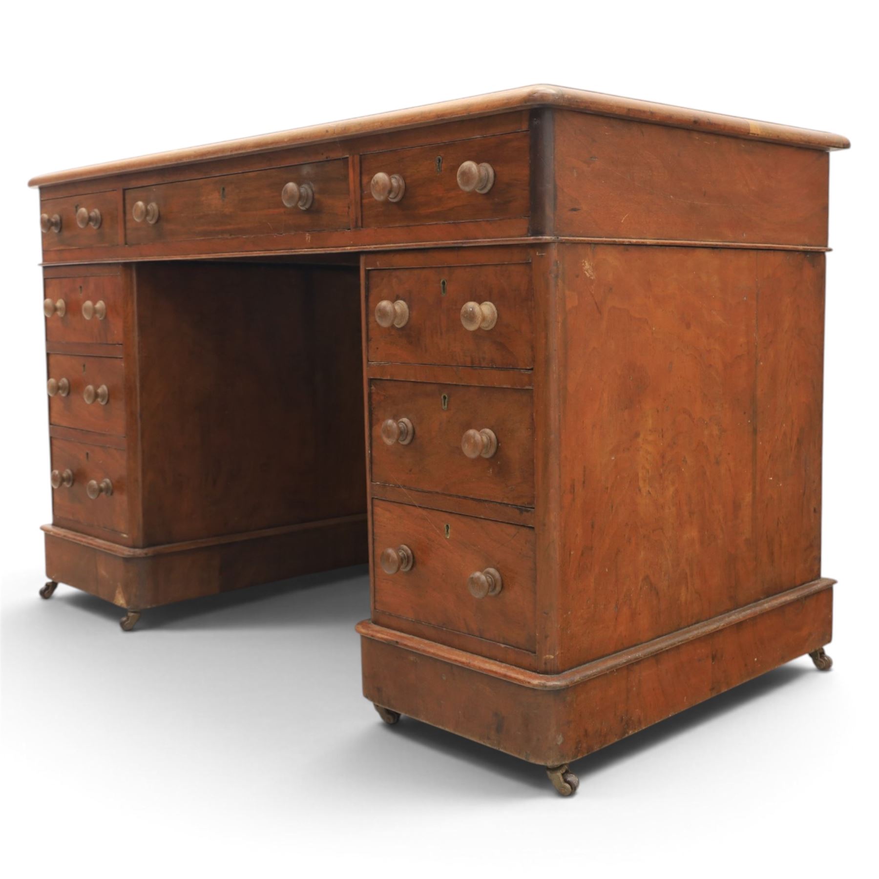 Victorian mahogany twin pedestal desk, rectangular top with red tooled leather writing surface with three frieze drawers, each pedestal with three drawers and castors