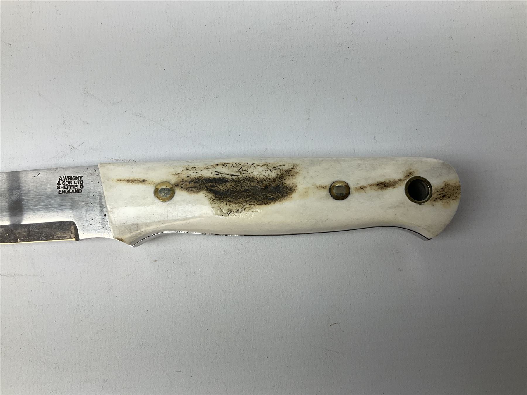 Three hunting knives, each blade marked A. Wright & Sons Sheffield, one with leather handle, one with horn handle and one with antler handle; each with leather sheath (3)