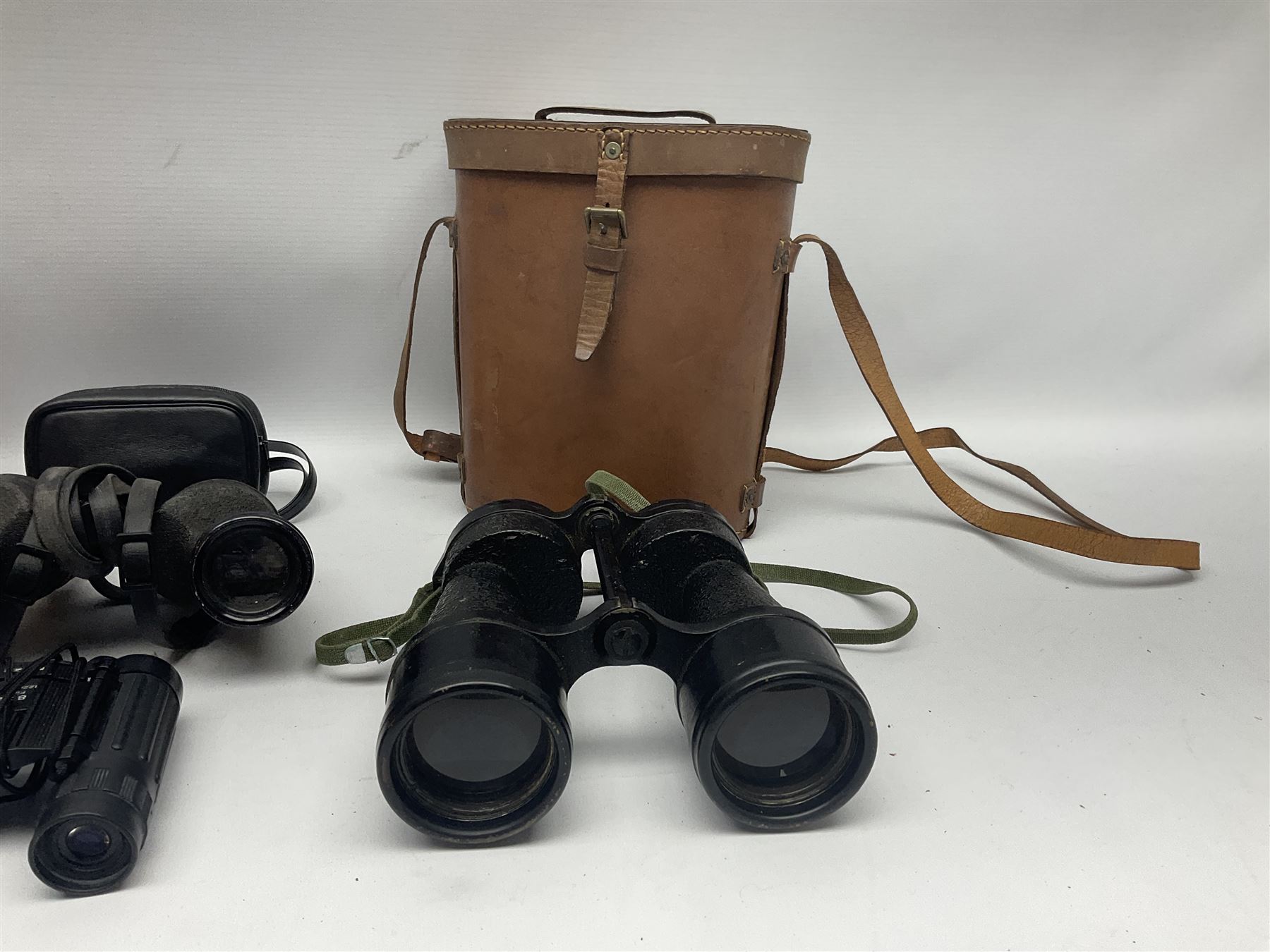 Pair of British World War Two issue black-painted binoculars, Bino 7x50 No. 5, 6E/320, No. 87412, MoD.B/42, with case, together with Nipole 10 x 50 binoculars and two other pairs