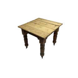 Edwardian pine and walnut dining table, square top over turned and fluted supports on castors
