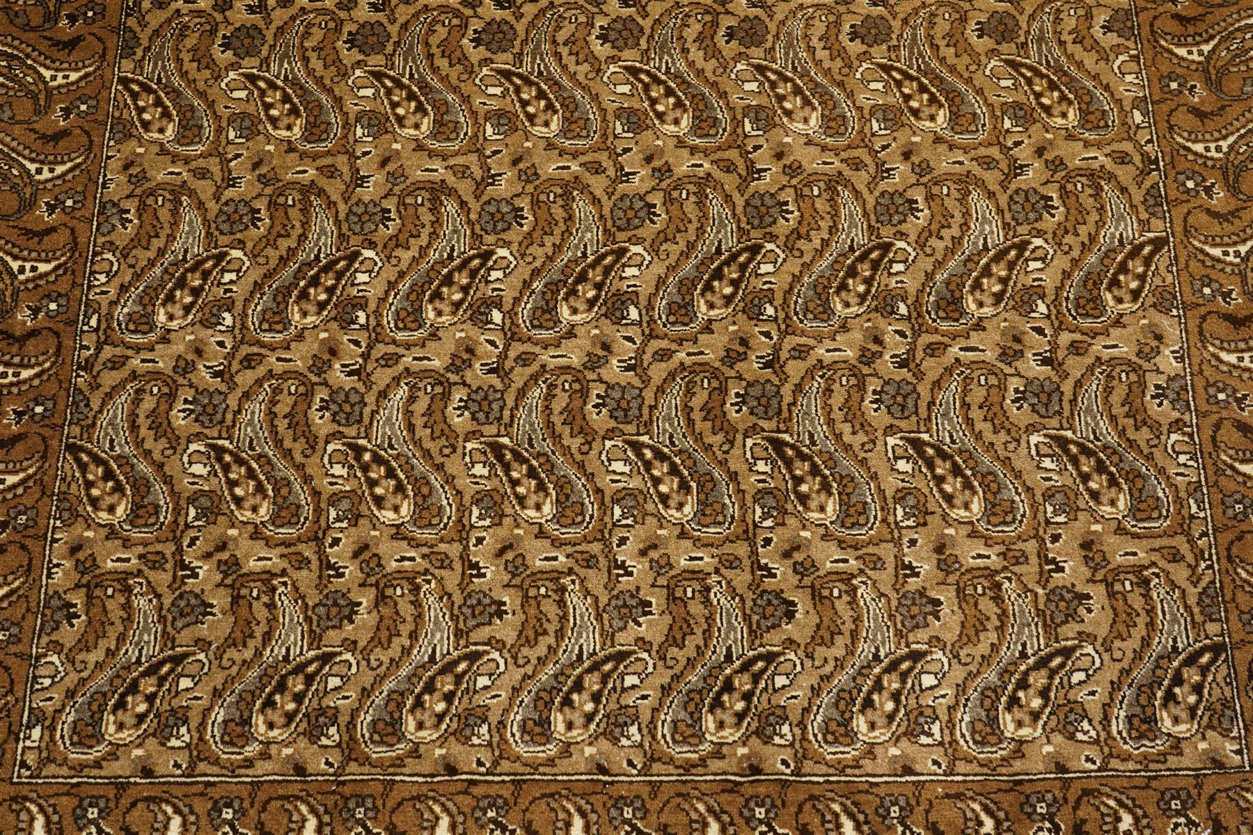 North West Persian Tabriz hand-knotted carpet, field with an all-over repeating boteh design arranged in rows, enclosed by a complimentary border flanked by guard stripes, in a palette of camel, beige and brown tones, with cotton fringe ends 