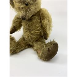 Early 20th century English teddy bear, WW1 period, with wood wool filled mohair body, fixed head with one boot button eye and vertically stitched nose and mouth and jointed limbs with cloth paw pads H16