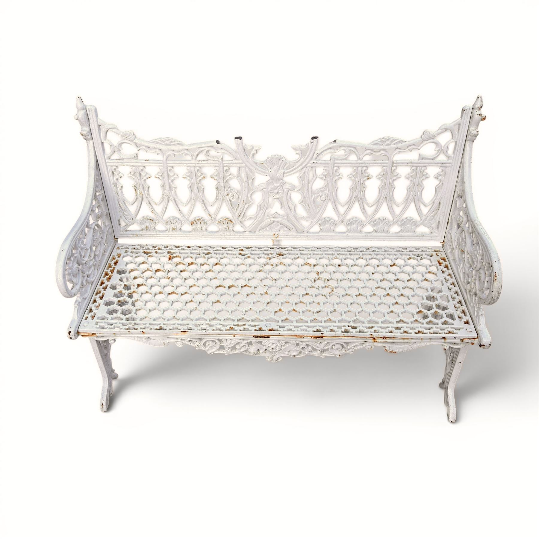 Victorian revival heavy cast iron garden bench, ornate back rest with scrolls, floral motifs and central crest, pierced lattice seat, curved arms and decorative legs, painted in antique white, in the Gothic Coalbrookdale style - Damaged 