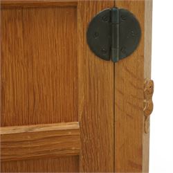 Beaverman - pair of oak bedside cabinets, each with plain rectangular top over single drawer and cupboard below with fielded panels and wrought iron hardware, with signature carved beaver, by the workshop of Colin Almack, Thirsk