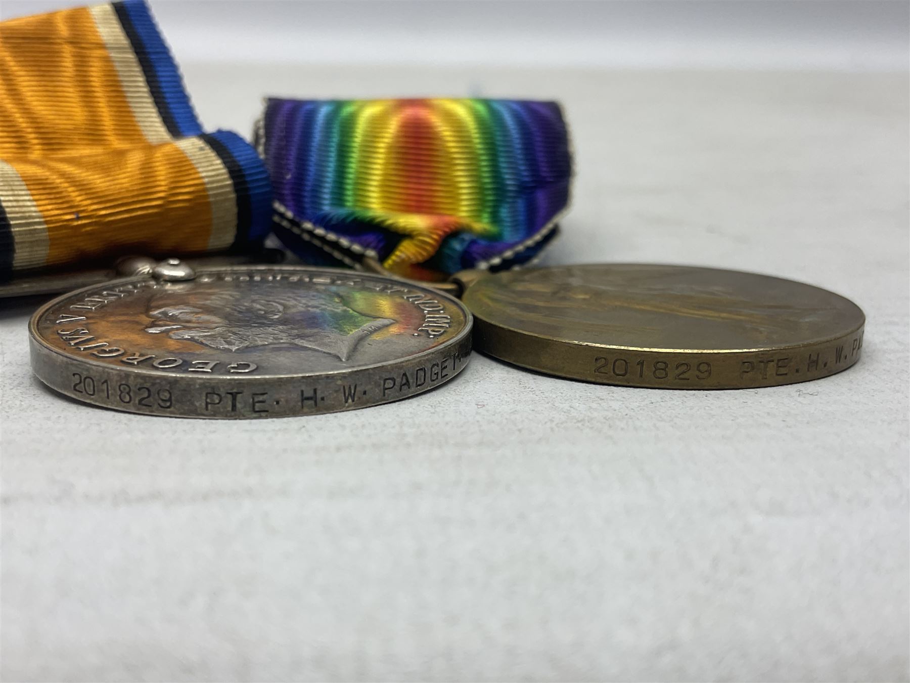 Family group of five WW1 medals for the East Yorkshire regiment comprising trio of 1914-15 Star, British War Medal and Victory medal awarded to 13-368 Pte. C. Padget; and British War Medal and Victory Medal to 201829 Pte. H.W. Padget; all with ribbons (5)