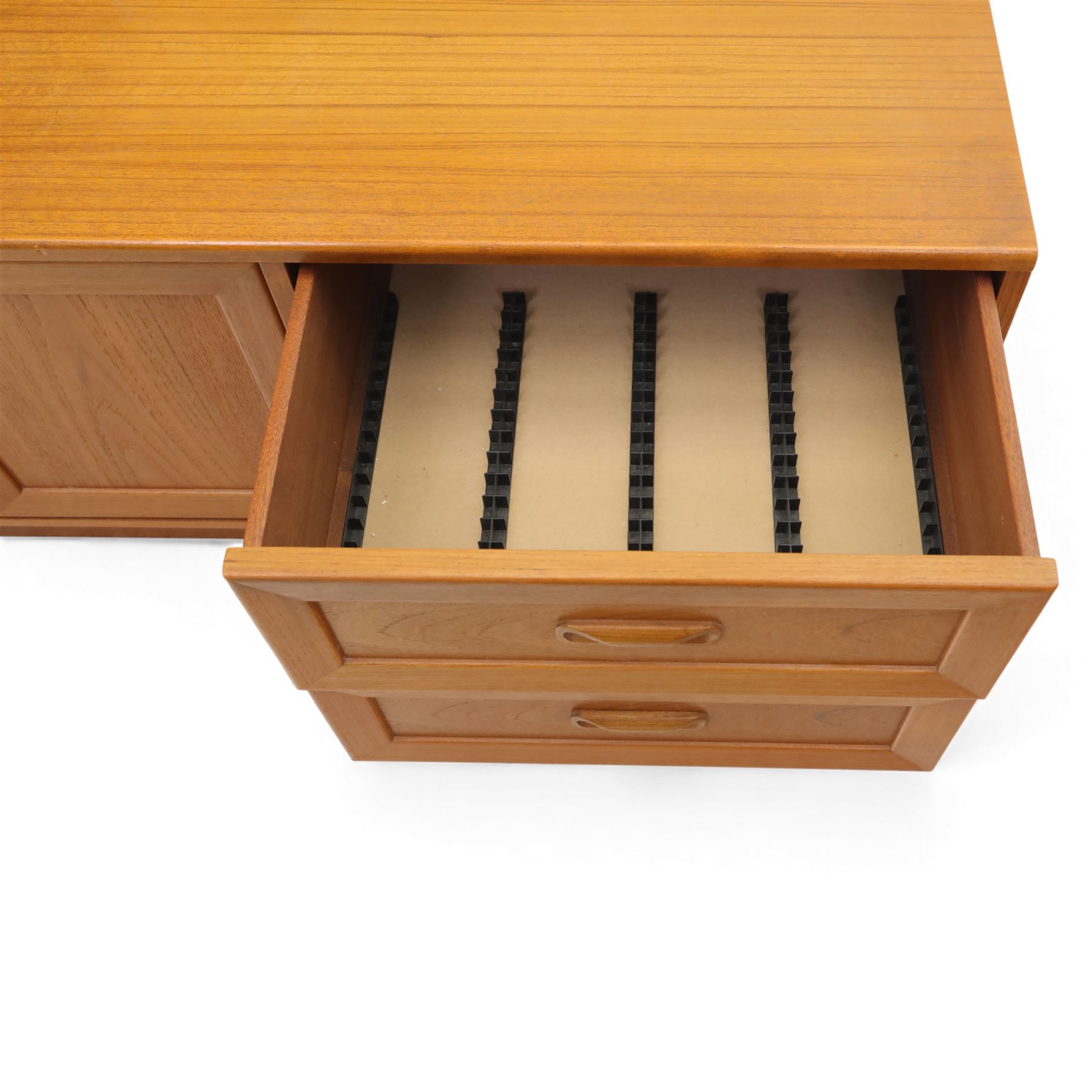 G Plan - 'Fresco' teak side unit, rectangular top above twin cupboard doors and two drawers, drawers fitted with cassette tape storage and a fall front drawer, raised on a plinth base