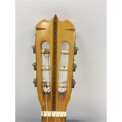 A Hondo guitar, with a 'Protection Racket' classcal 7052 case.