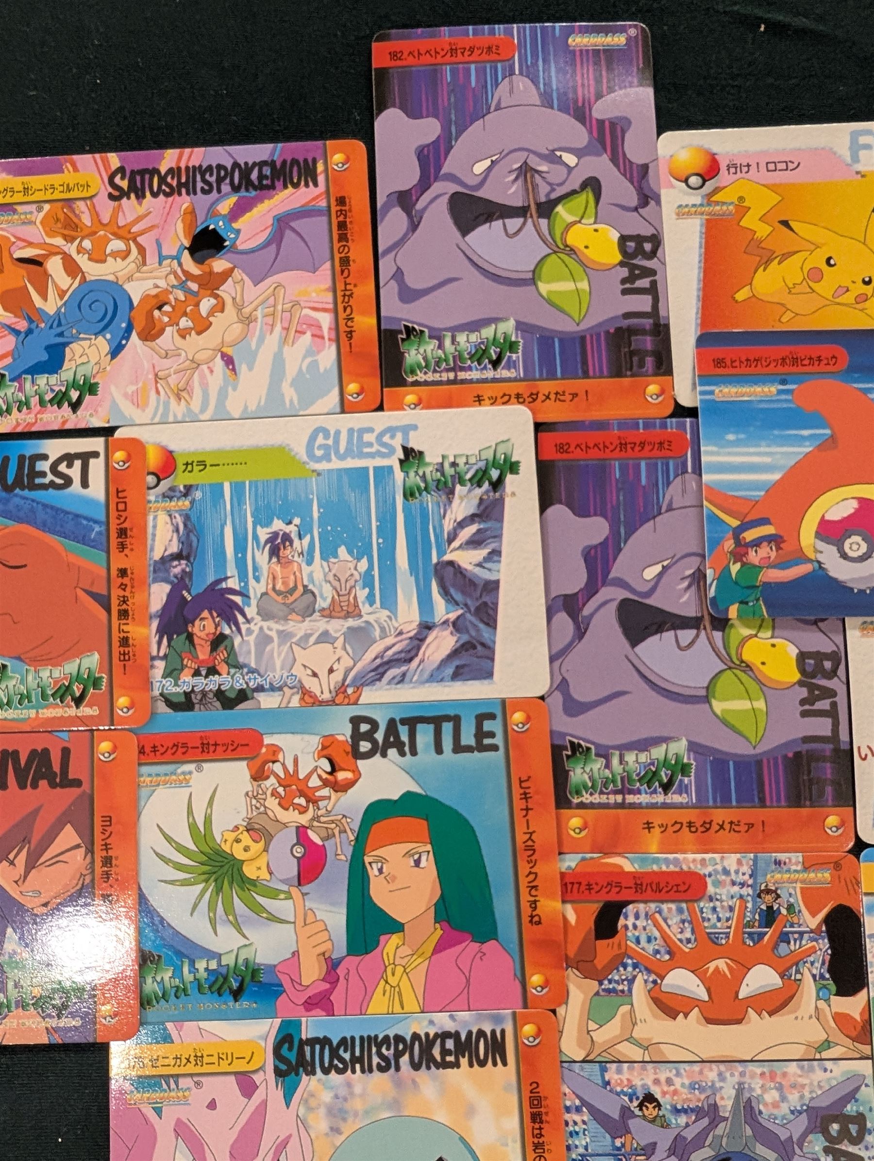 Collection of Pokemon TGC trading cards, including two WB First Movie Black Star promo cards Pikachu no. 4 and Dragonite no. 5, two Ancient Mew Black Star holo promo cards, Gym Challenge Giovanni's Persian 8/132 holo and a small collection WOTC, Neo Discovery and Neo Genesis cards, together with thirty four Bandai Carddass Pokemon cards, including prism Charizard no. 186 and Pokemon Topps cards including holo examples 