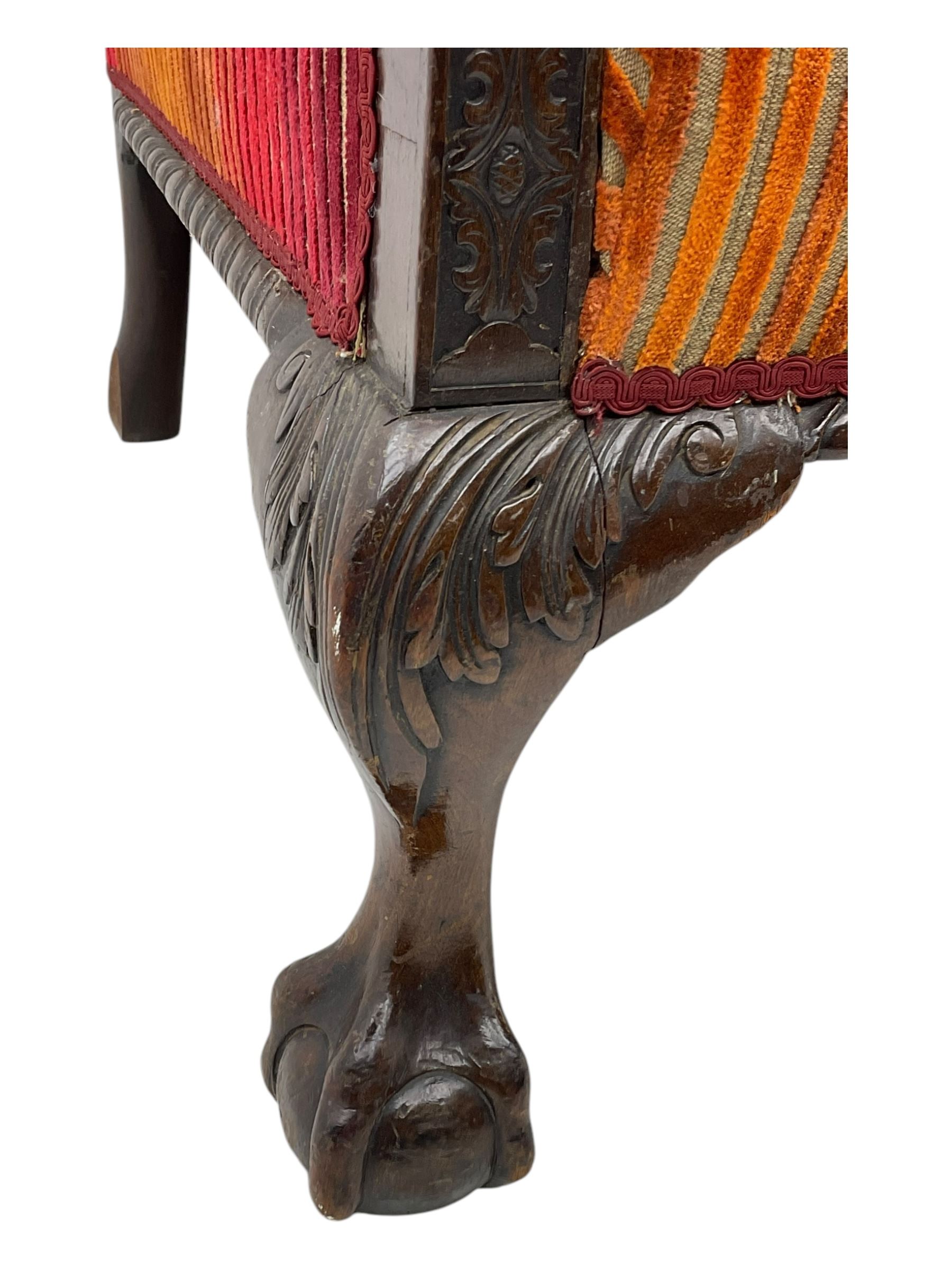 Mid-19th century mahogany two-seat sofa, upholstered in striped velvet fabric, the shaped backrest leading to outward-curved arms, carved apron with scrolling foliate details, raised on cabriole supports terminating in claw and ball feet