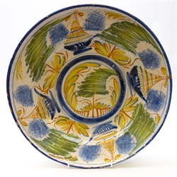  18th century Delft pancake plate, decorated in polychrome enamels with a continuous motif of sailing boats amongst stylized trees, D30.5cm     