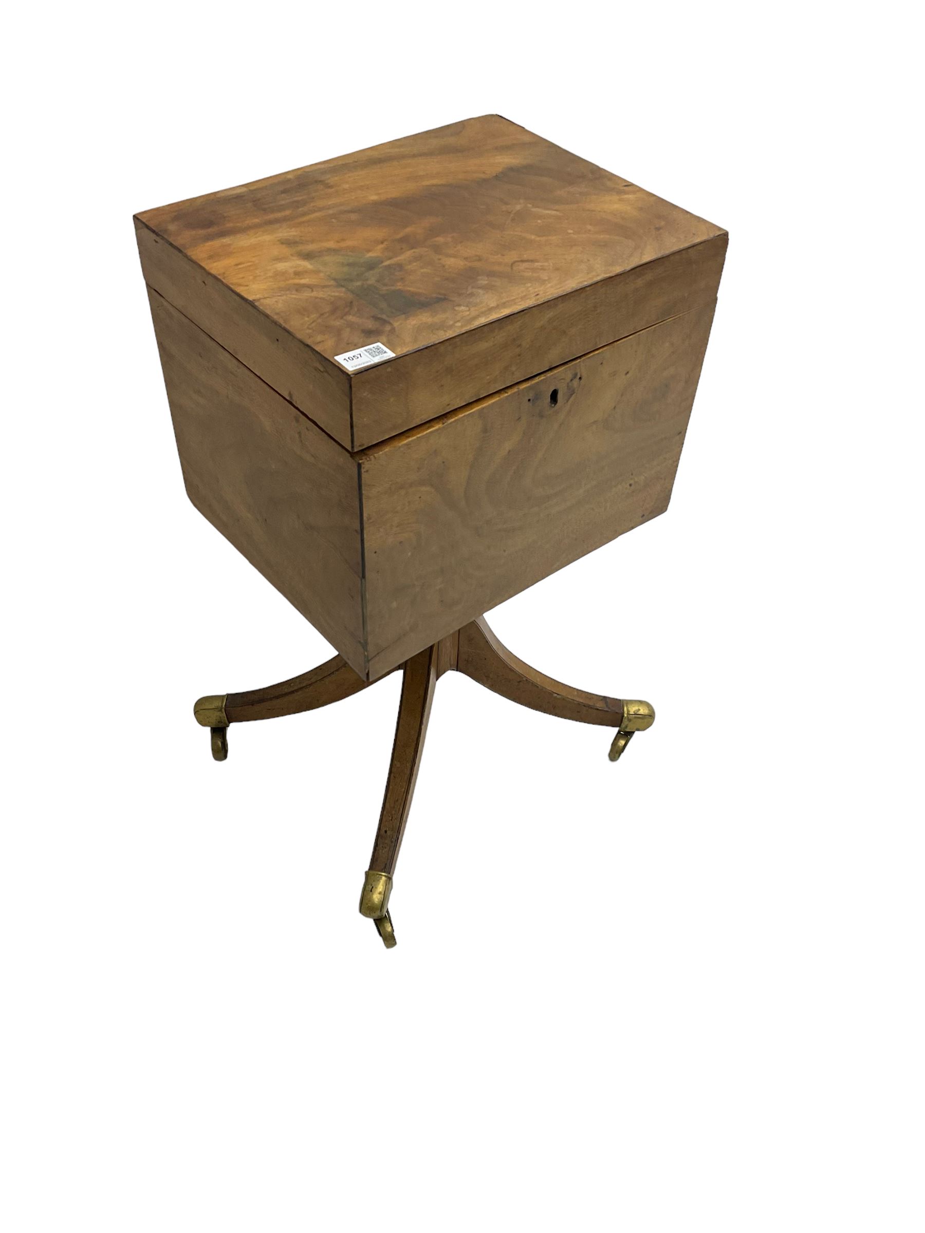 Regency mahogany cellarette on stand, rectangular top with hinged lid, raised on turned pedestal terminating in quadrupod base with brass cups and castors
