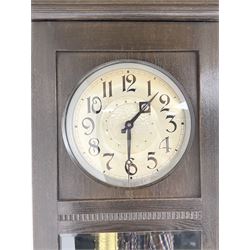 20th century Art Deco- oak cased 8-day longcase clock c1930, flat topped case with a fully glazed door on a stepped plinth, silvered circular dial with Arabic numerals and pierced steel hands, chain driven twin train movement with  4 gong rods. With pendulum and two brass cased weights.
