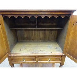  Bevan Funnell Reprodux oak court cupboard, two fielded panelled doors enclosing a fitted interior, above two drawers on turned supports joined by a solid undertier, W98cm, H136cm, D48cm  