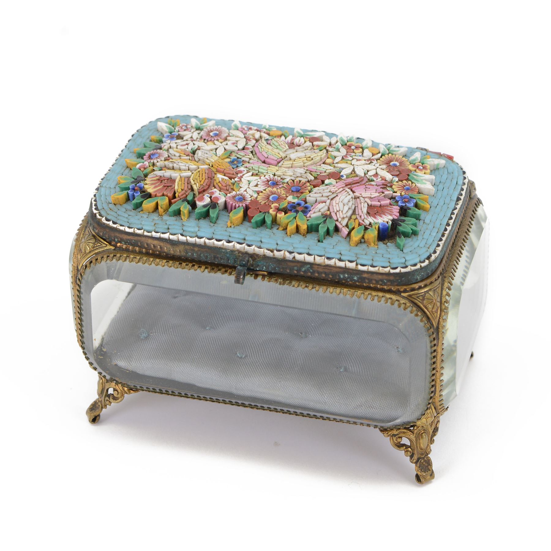 Micro mosaic jewellery casket with bevelled glass sides, the hinged lid decorated with with multicoloured raised flowers upon a blue ground, raised upon pierced gilt feet H10cm, L15cm