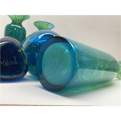 Quantity of M’dina art glass to include a streaked blue and green bottle form vase with captured bubble design and slender neck, H35cm, along with a paperweight, ovoid form vase and another vase all decorated in a blue, brown and white colour way, other contemporary glass examples etc with etched marks beneath