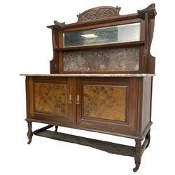 Late Victorian walnut washstand, raised back with carved pediment over bevelled mirror and marble panels, rectangular marble top, fitted with two figured panel doors, on turned supports