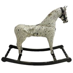Late 19th to early 20th century painted leather dappled grey rocking horse, with leather bridle, on ebonised base with turned end stretchers