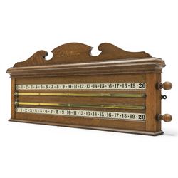 E.J. Riley - 20th century oak billiards scorer, with broken arch pediment with gilt markers mark, with revoling scorer with turned knob, brass indicator, with brass wall hangers