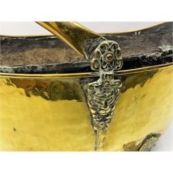 Brass coal bucket of oval form, with swing handle and lion mask decoration, raised on four lion's paw feet, L48cm, and three graduating jam pans