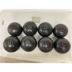 Eight lawn green bowling balls, comprising Helmselite Super-Grip sizes 2 and 5, in two sets of four