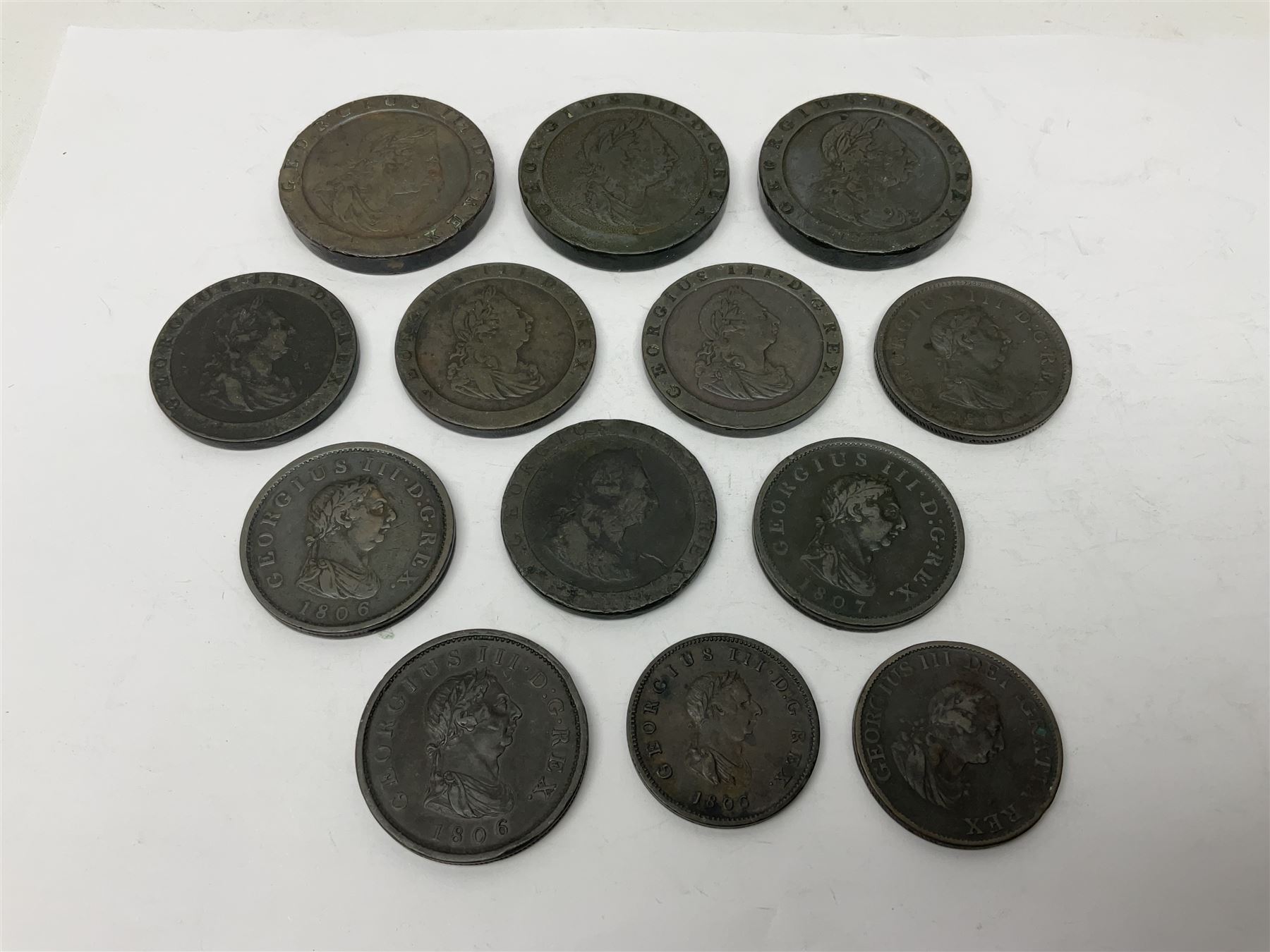 Two George III halfpenny coins dated 1799 and 1806, four pennies dated three 1806 and 1807, four 1797 cartwheel pennies and three 1797 cartwheel two pence coins