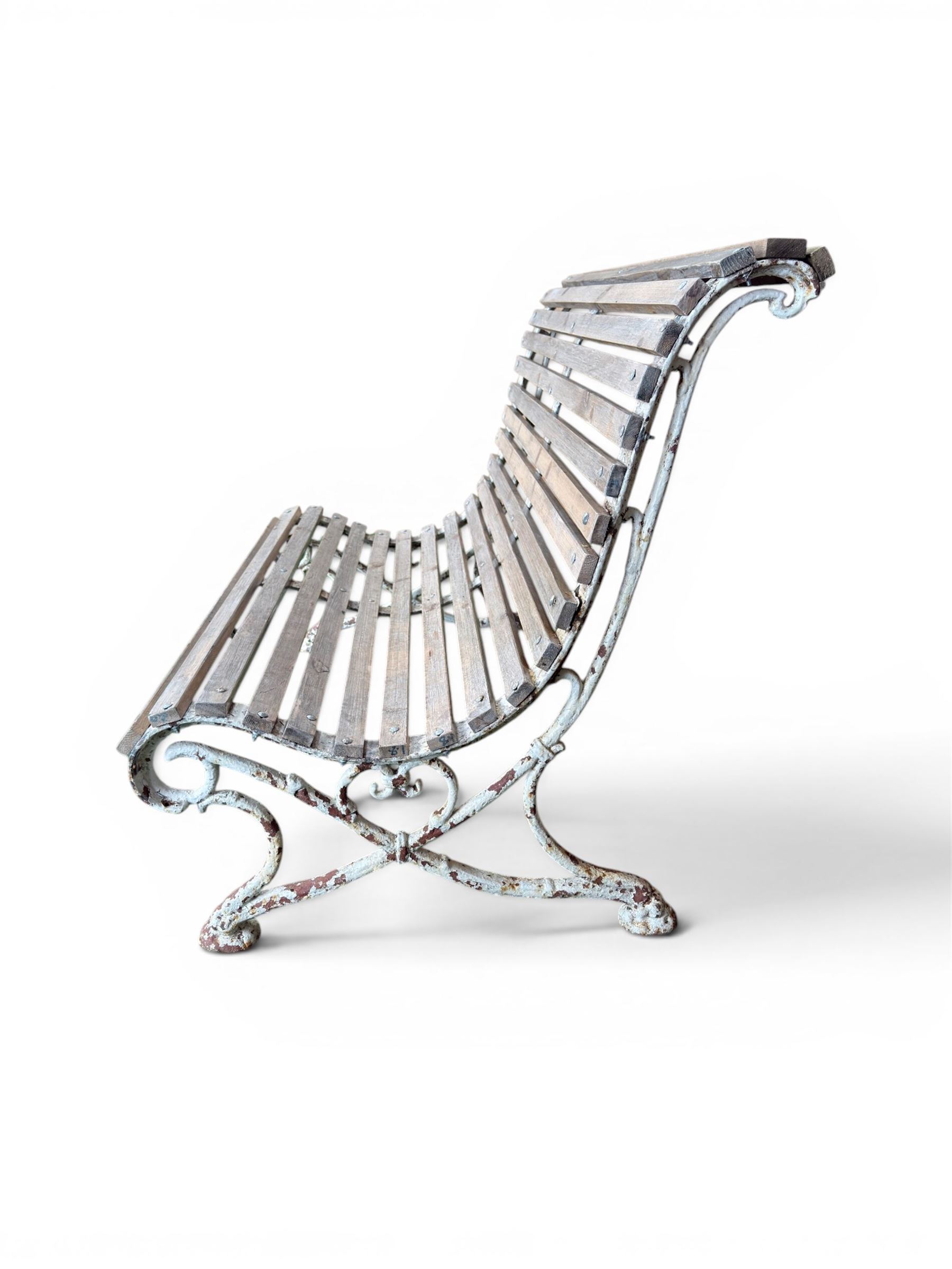 19th century cast iron and wood slatted garden bench, high scroll back form, low X shaped base, finished in distressed white paint