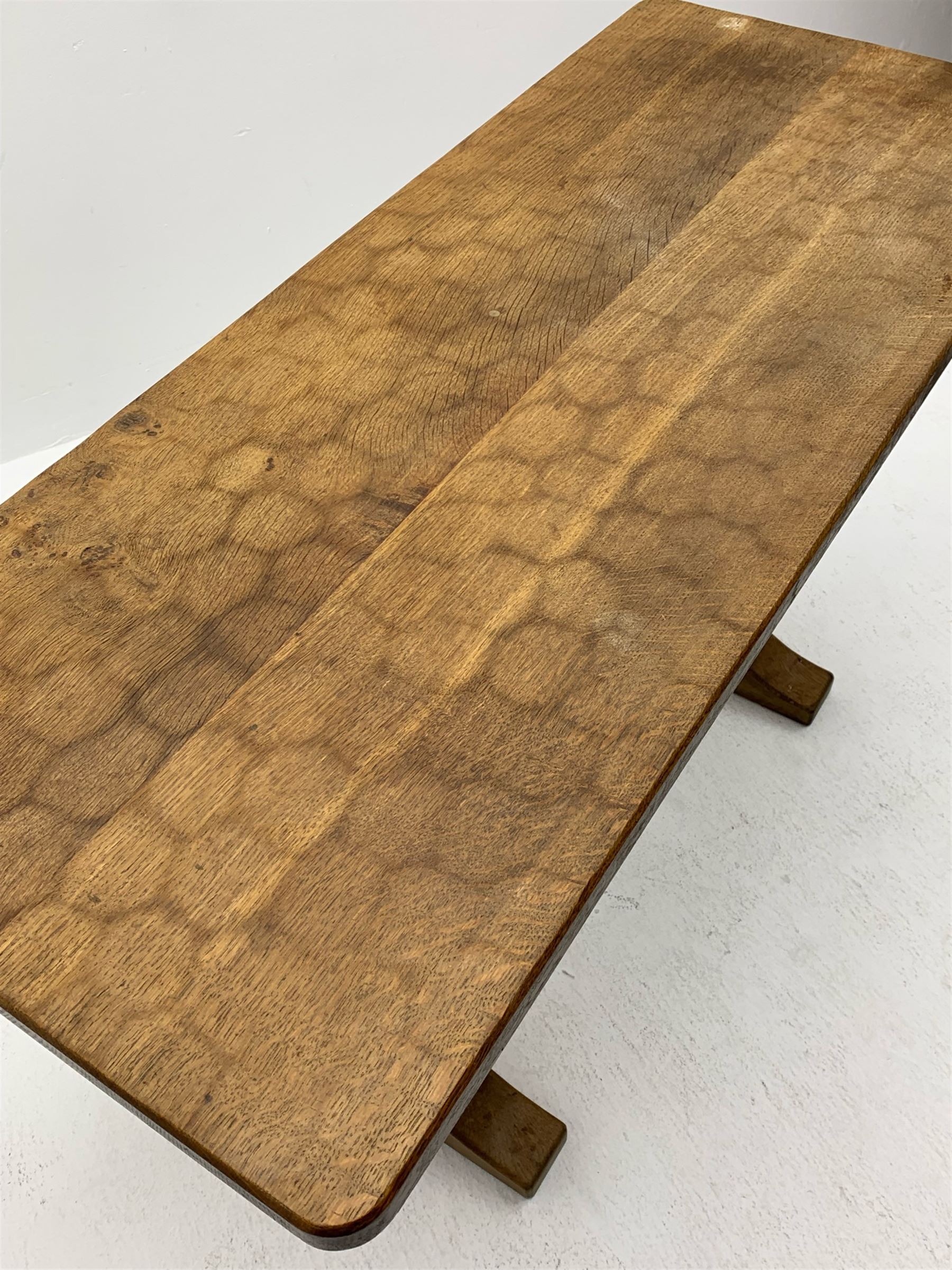 'Acornman' oak table with rectangular adzed top, shaped end supports on sledge feet joined by pegged stretcher carved with acorn signature, by Alan Grainger of Brandsby, York