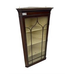 Early 20th century Georgian design mahogany wall-mounted corner display cabinet, projecting cornice with dentil frieze over astragal glazed door enclosing three fabric-lined shelves